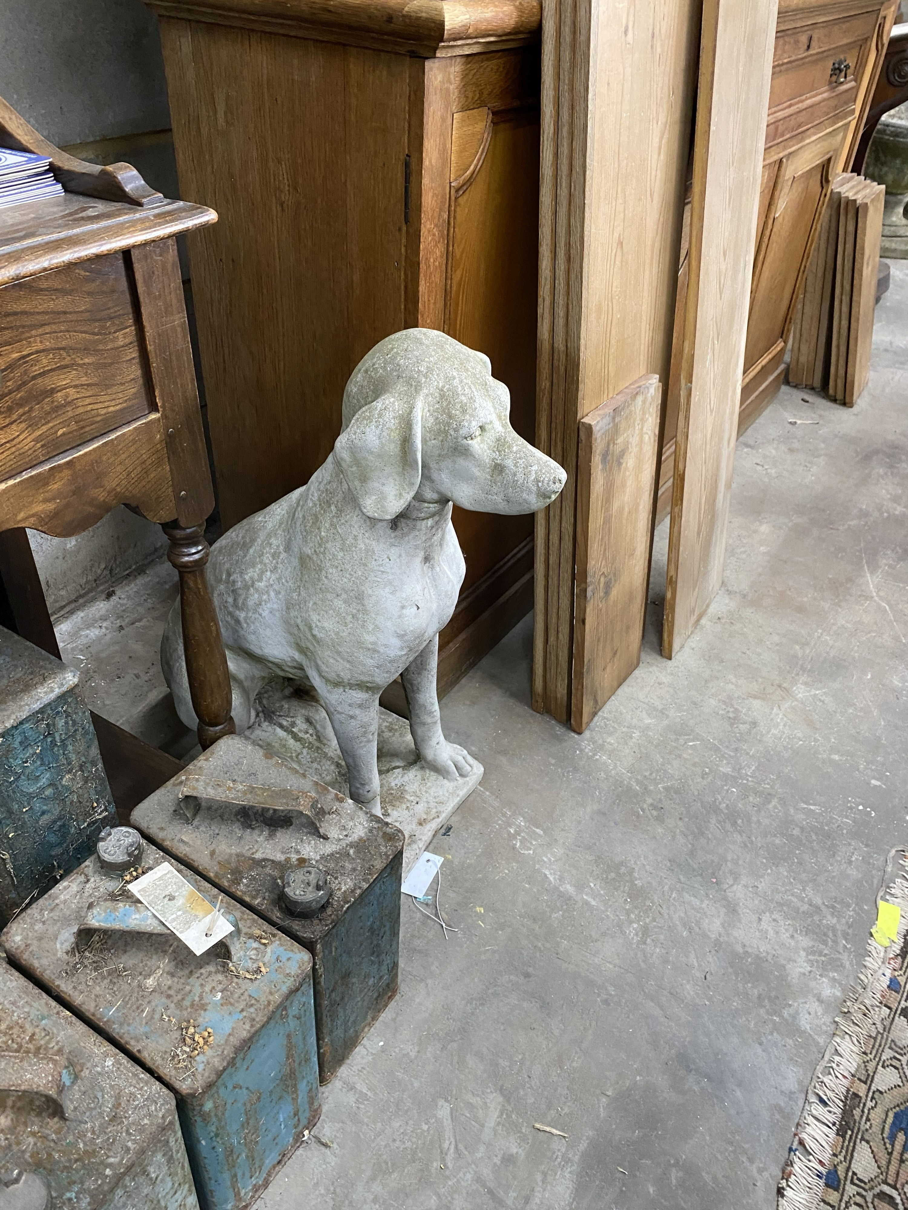 A pair of reconstituted stone seated hound garden ornaments, height 70cm